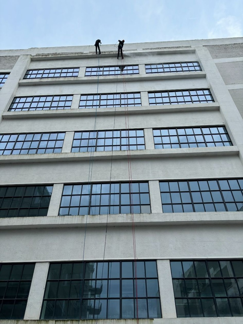 West End Window Cleaners rope access operatives descending a high-rise building facade in London for window cleaning